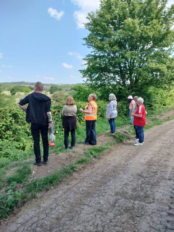Walking group from behind stopping to look at nature reserve